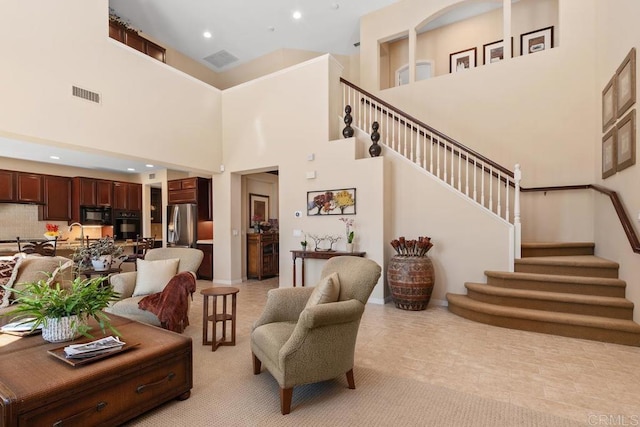 living room with stairway, visible vents, and recessed lighting