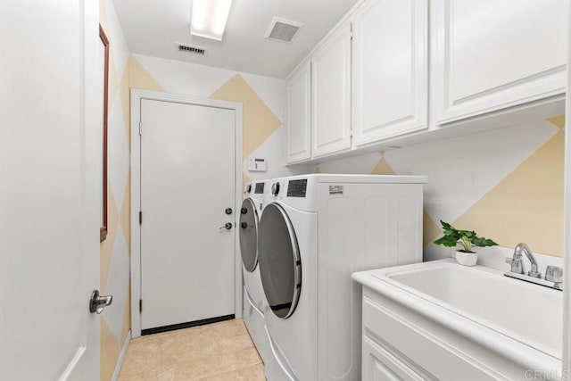 laundry room with visible vents, separate washer and dryer, a sink, and cabinet space