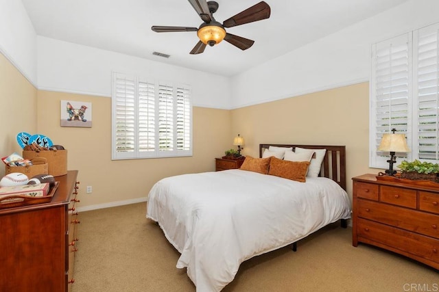 bedroom featuring visible vents, carpet floors, a ceiling fan, and baseboards