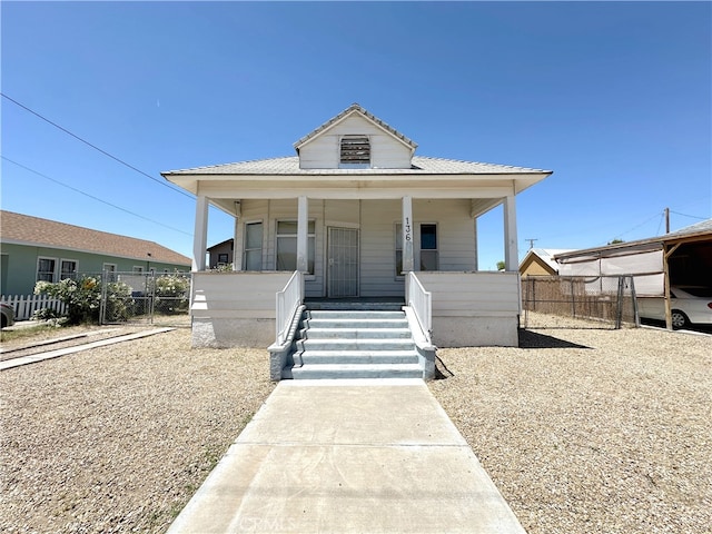 view of front of home with a porch and a carport