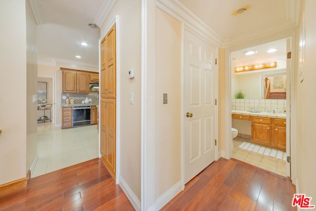 hall with dark hardwood / wood-style flooring and crown molding