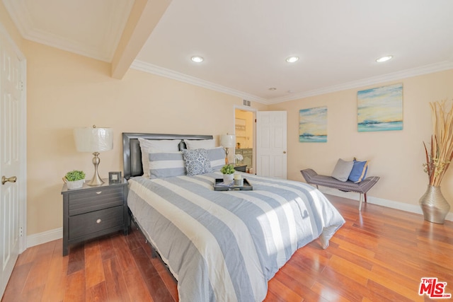 bedroom featuring beam ceiling, crown molding, and hardwood / wood-style floors