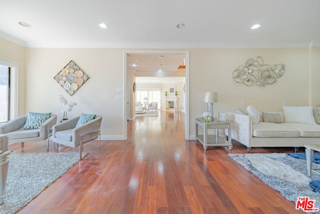 living room featuring crown molding and hardwood / wood-style flooring