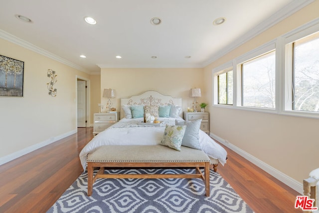 bedroom with hardwood / wood-style flooring and ornamental molding