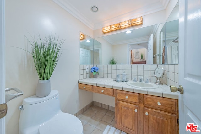 bathroom featuring tasteful backsplash, toilet, tile patterned floors, and crown molding