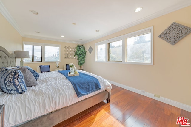 bedroom with wood-type flooring and ornamental molding