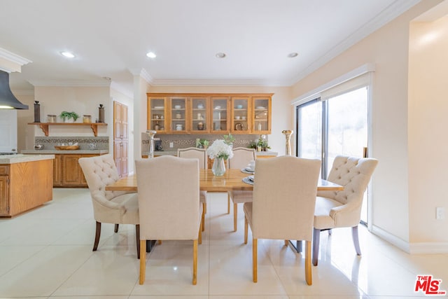 tiled dining area featuring ornamental molding