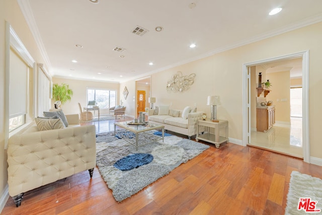 living room featuring crown molding and hardwood / wood-style floors