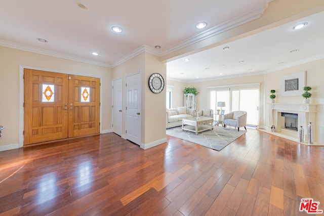 foyer entrance with hardwood / wood-style flooring and ornamental molding