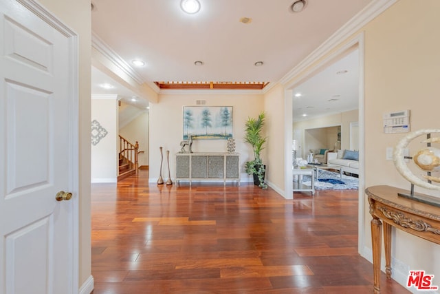 hallway with ornamental molding and dark hardwood / wood-style floors