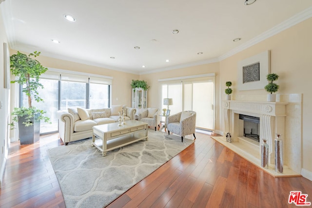 living room with light hardwood / wood-style flooring and ornamental molding