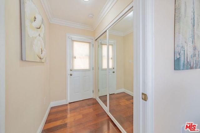 doorway to outside featuring wood-type flooring and crown molding