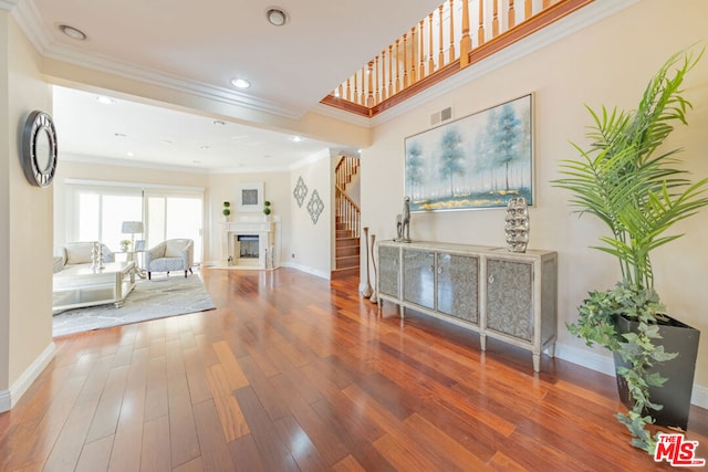 hall featuring hardwood / wood-style flooring and crown molding