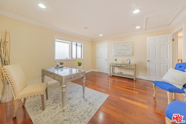 home office featuring ornamental molding and hardwood / wood-style flooring