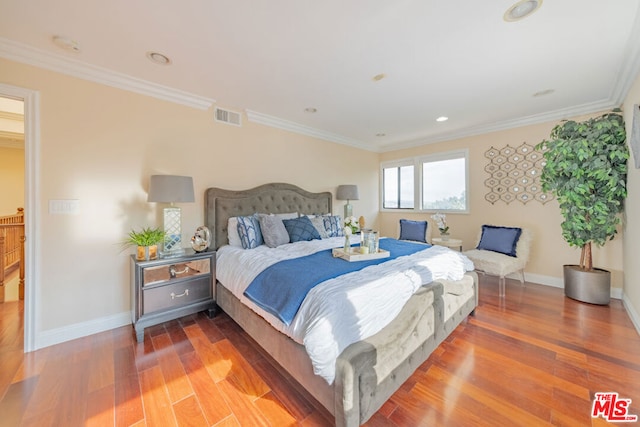 bedroom featuring crown molding and hardwood / wood-style floors