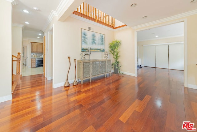 spare room featuring ornamental molding and wood-type flooring