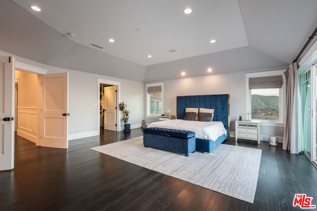 bedroom with lofted ceiling and dark hardwood / wood-style floors