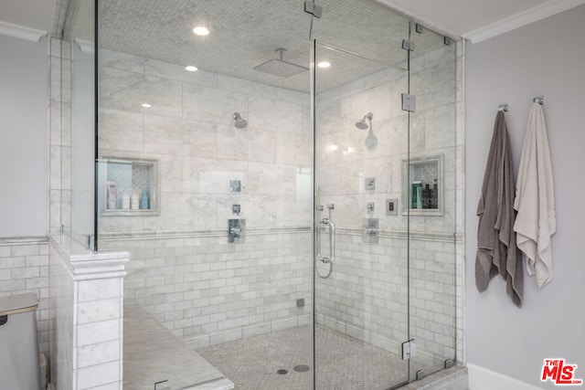 bathroom with tile walls, ornamental molding, and an enclosed shower