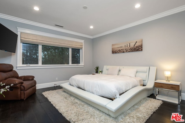 bedroom with crown molding and dark hardwood / wood-style flooring