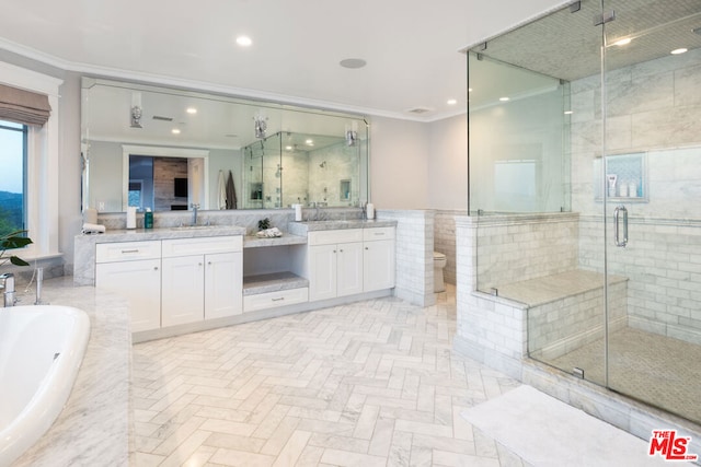 bathroom with plus walk in shower, vanity, and crown molding