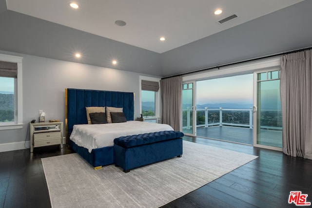 bedroom with dark wood-type flooring and access to exterior