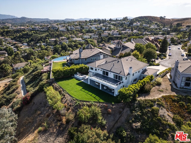 birds eye view of property with a mountain view