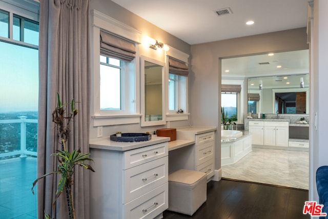 bathroom with vanity, hardwood / wood-style floors, and a bathing tub