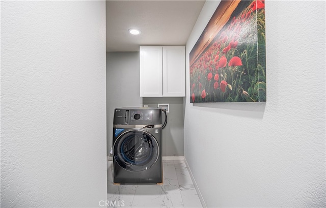 laundry area featuring hookup for a washing machine and cabinets