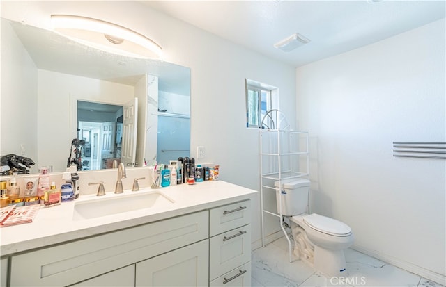 bathroom featuring walk in shower, vanity, and toilet