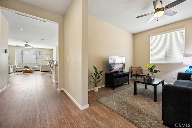 living room with ceiling fan and hardwood / wood-style floors