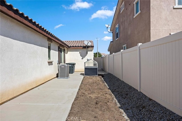 view of yard featuring a patio area and central air condition unit