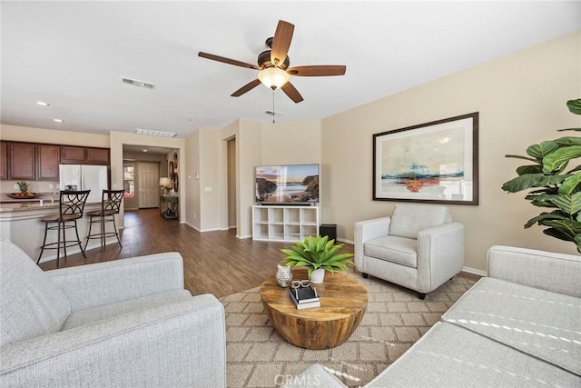 living room with light hardwood / wood-style floors and ceiling fan