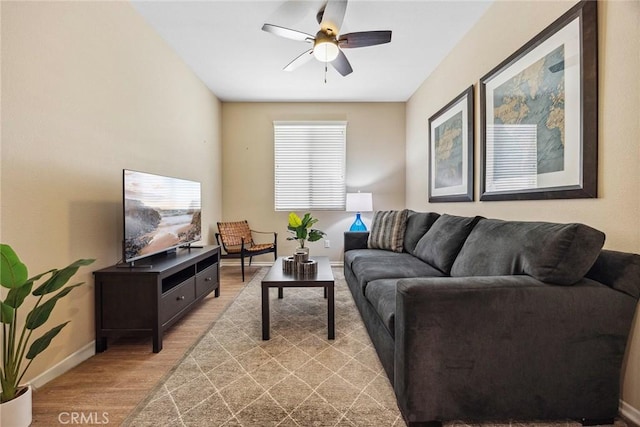 living room featuring ceiling fan and light wood-type flooring