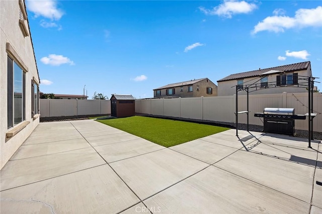 view of yard featuring a shed and a patio area