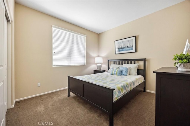 bedroom with dark carpet and a closet