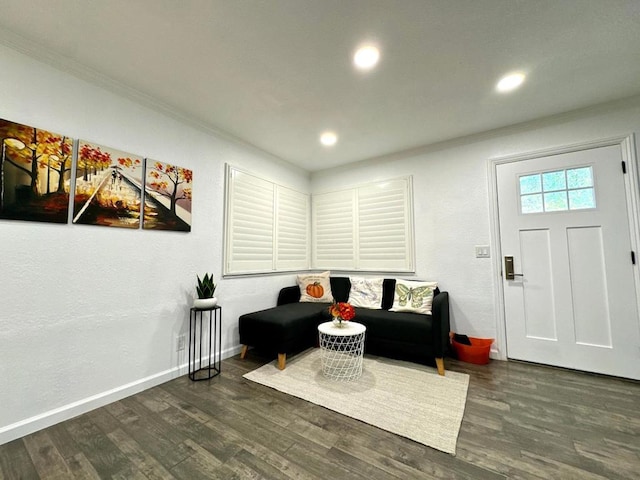 living room with dark hardwood / wood-style floors and ornamental molding