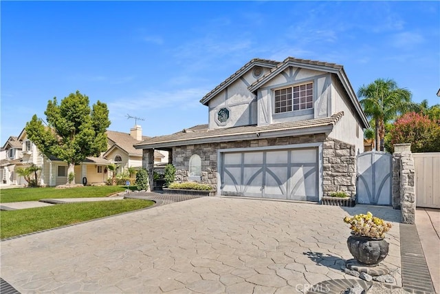 tudor-style house featuring a garage