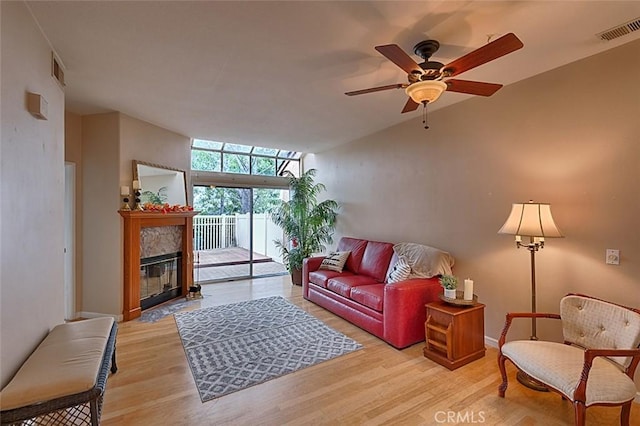 living room featuring ceiling fan and light wood-type flooring