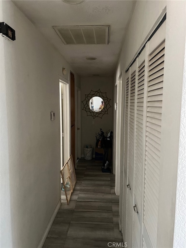 hallway featuring dark wood-type flooring