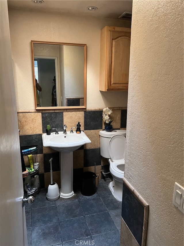 bathroom with sink, toilet, and tile patterned floors