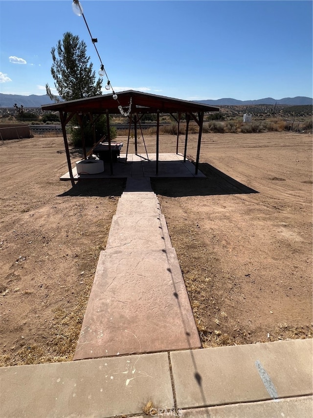 view of yard with a mountain view and a gazebo