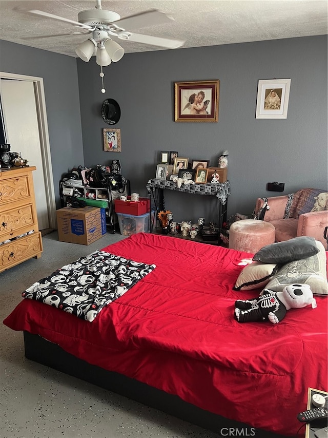 bedroom with ceiling fan and a textured ceiling