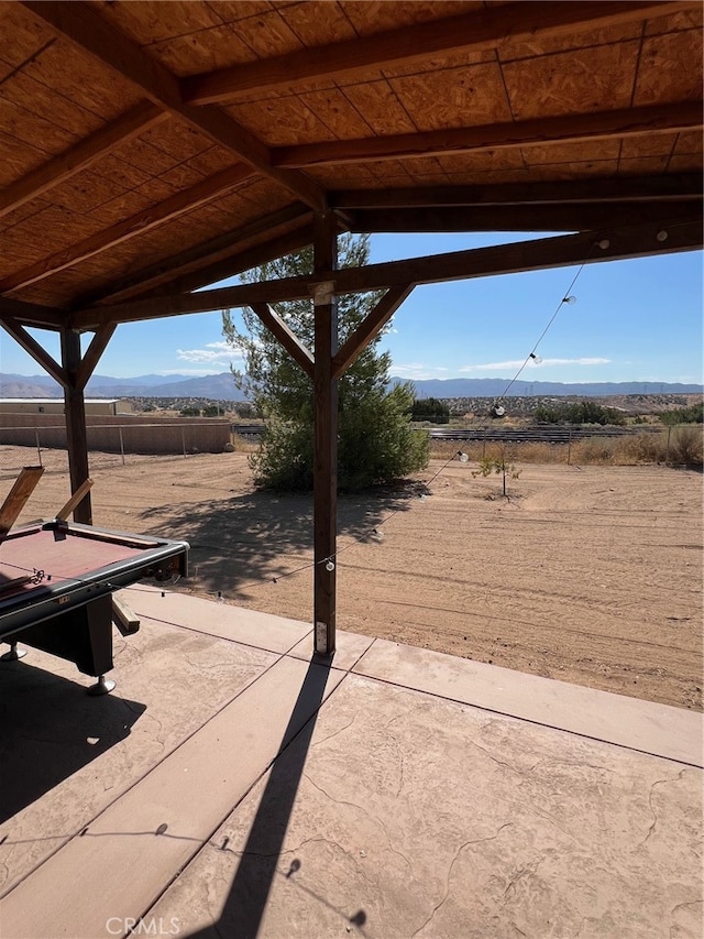 view of patio / terrace with a mountain view and a rural view