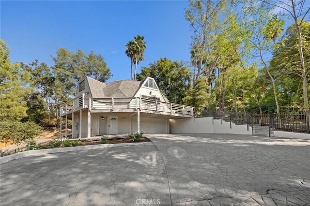 view of front facade with a deck and a garage