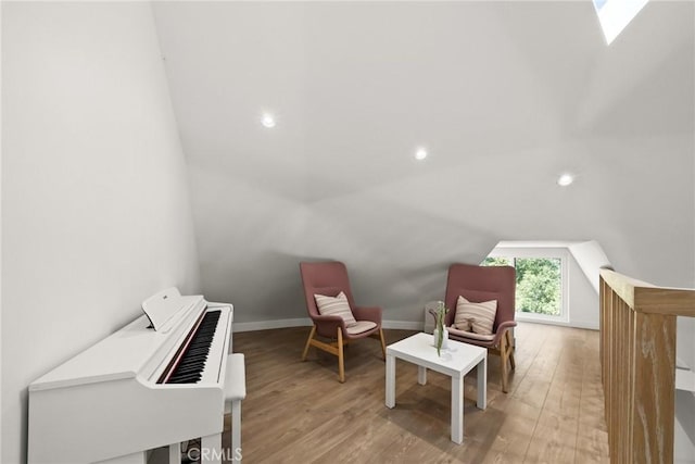 sitting room with vaulted ceiling and light hardwood / wood-style floors