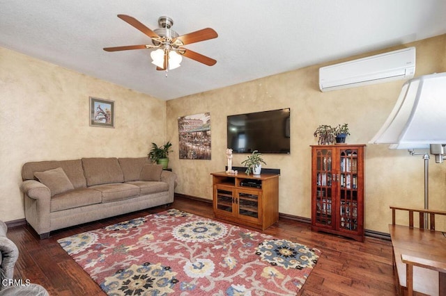 living room with a wall mounted AC, dark wood-type flooring, and ceiling fan