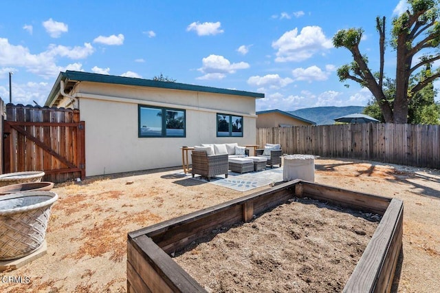 rear view of property featuring a patio area, a mountain view, and an outdoor hangout area