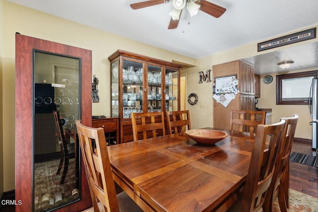 dining area with wood-type flooring and ceiling fan