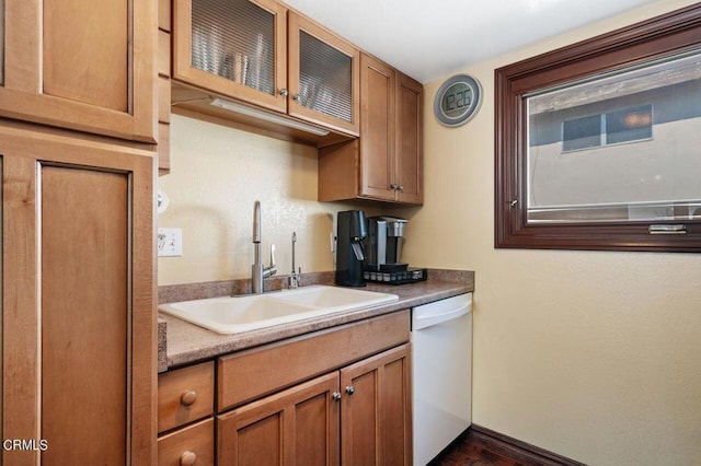 kitchen featuring white dishwasher, sink, and dark hardwood / wood-style flooring