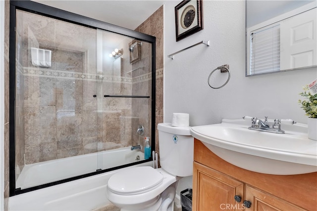 full bathroom featuring shower / bath combination with glass door, vanity, and toilet